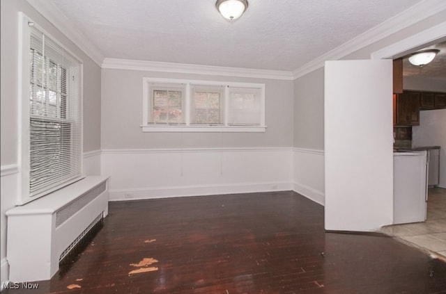 empty room with dark wood-type flooring, crown molding, and a healthy amount of sunlight