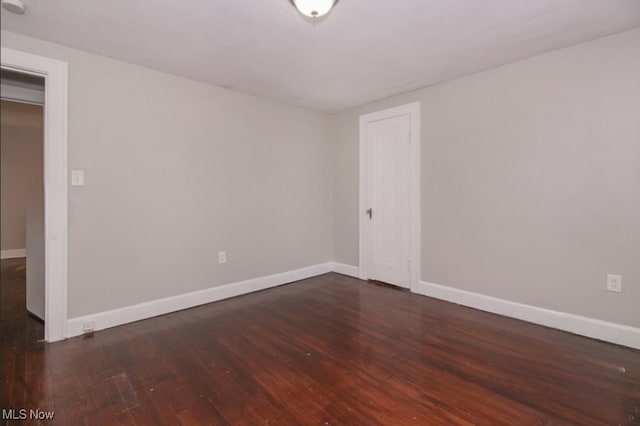 unfurnished room with dark hardwood / wood-style floors