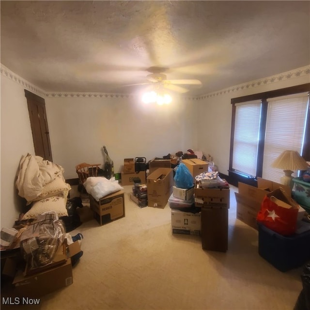 interior space featuring ceiling fan and carpet flooring