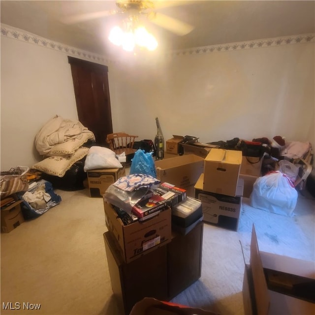 carpeted living room with ceiling fan