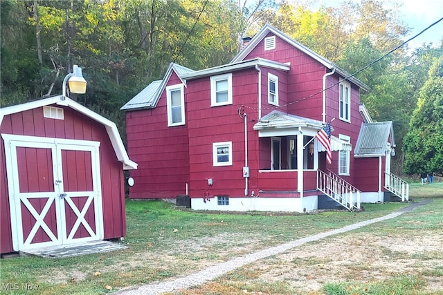 view of outbuilding featuring a lawn and central AC unit