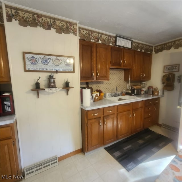 kitchen featuring ornamental molding and sink