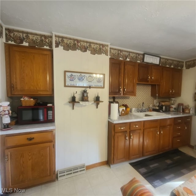 kitchen with crown molding and sink