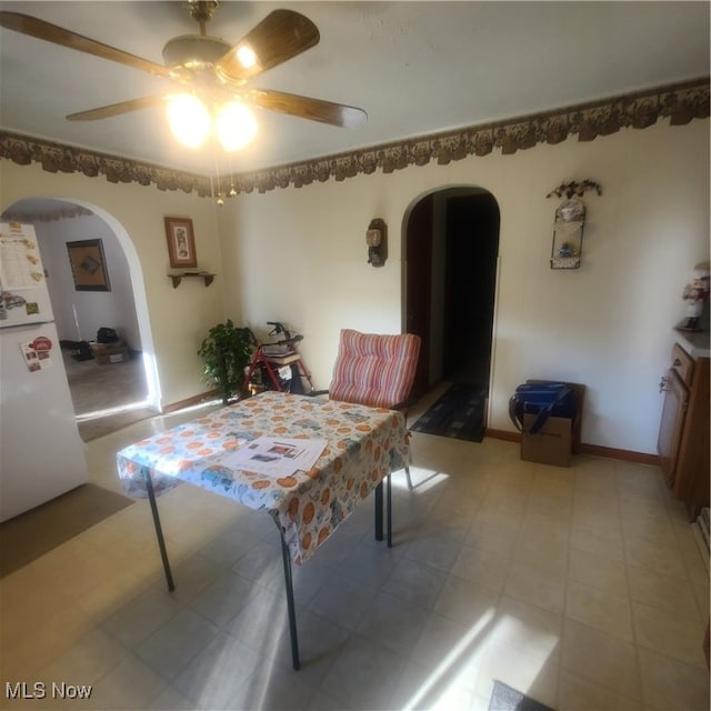 dining area with light tile patterned flooring and ceiling fan