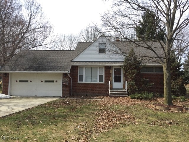 view of front facade with a garage and a front lawn