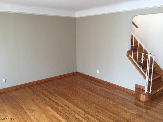 unfurnished room with hardwood / wood-style floors