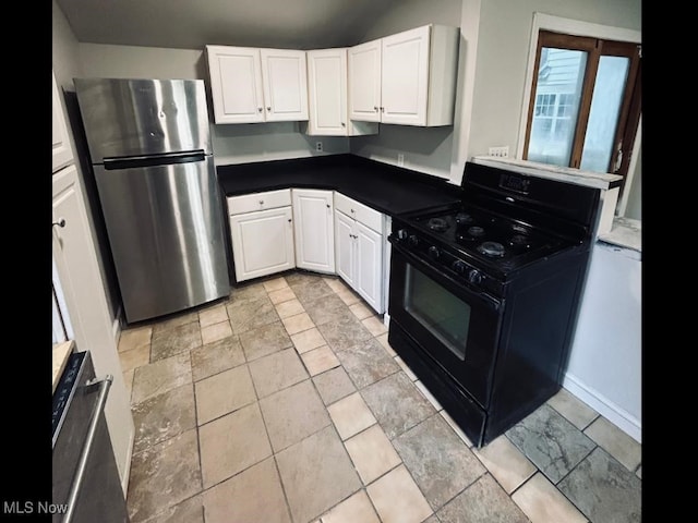 kitchen with white cabinets, stainless steel fridge, and black range with gas stovetop