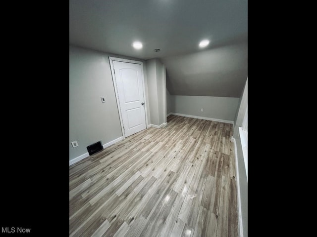 bonus room featuring vaulted ceiling and light hardwood / wood-style floors