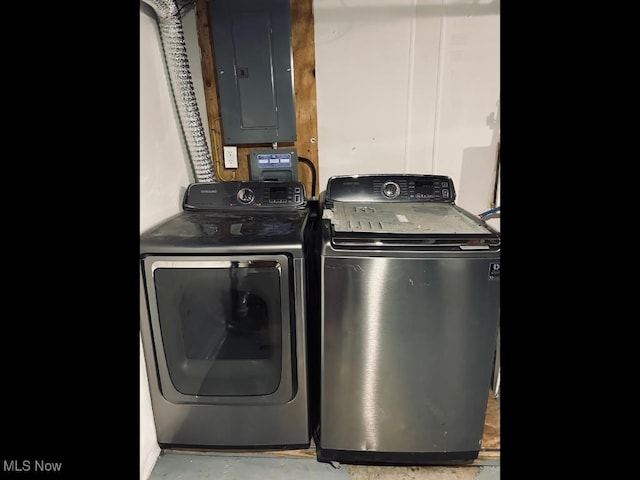 clothes washing area featuring electric panel and independent washer and dryer