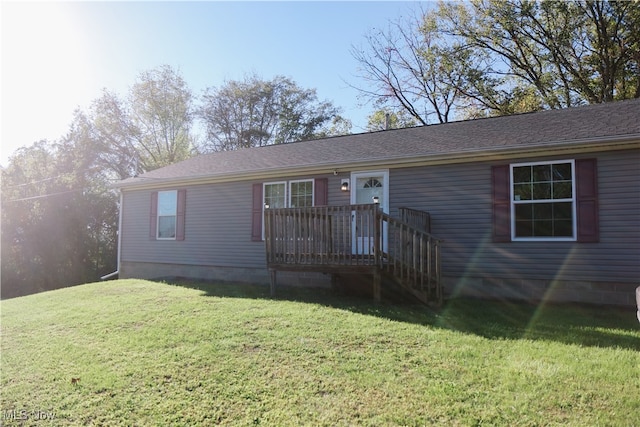 view of front of property with a front yard and a deck