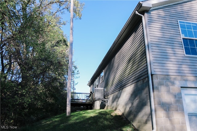 view of side of property featuring a wooden deck and a yard