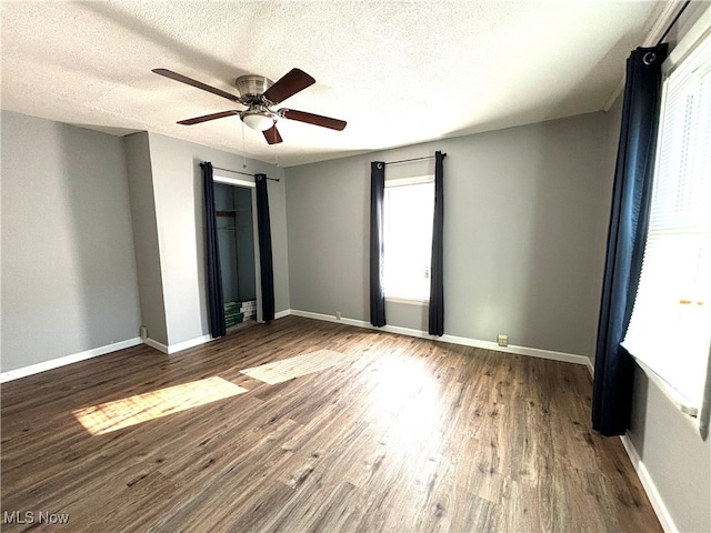 unfurnished room with a textured ceiling, ceiling fan, and hardwood / wood-style flooring