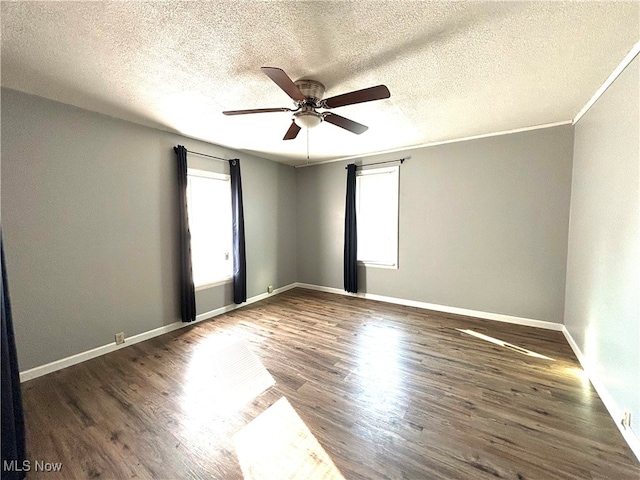 spare room with dark wood-type flooring, a textured ceiling, and ceiling fan