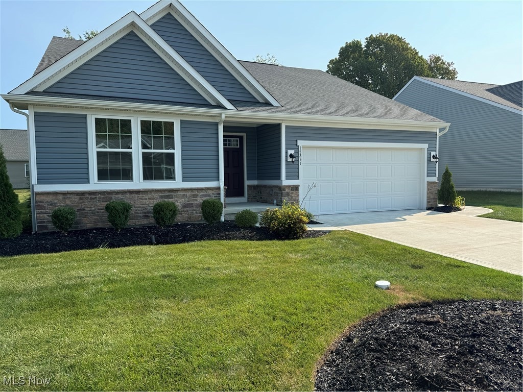 craftsman-style home with a garage and a front yard