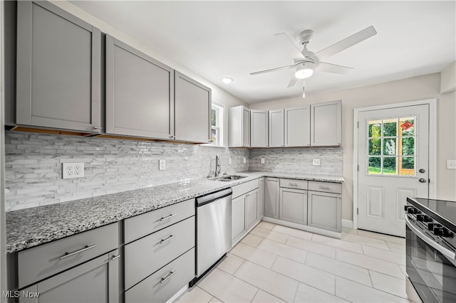 kitchen with appliances with stainless steel finishes, tasteful backsplash, gray cabinets, ceiling fan, and sink