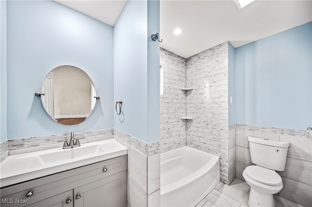 full bathroom featuring tile walls, vanity, toilet, and shower / bath combination