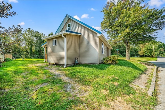 view of property exterior with a lawn