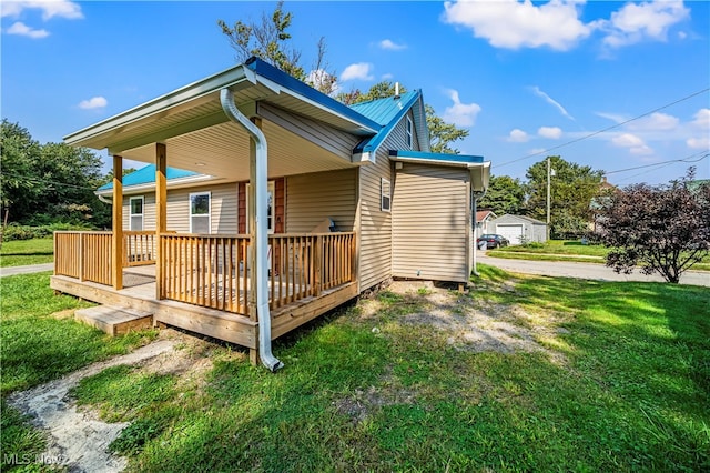 view of property exterior featuring a wooden deck and a lawn