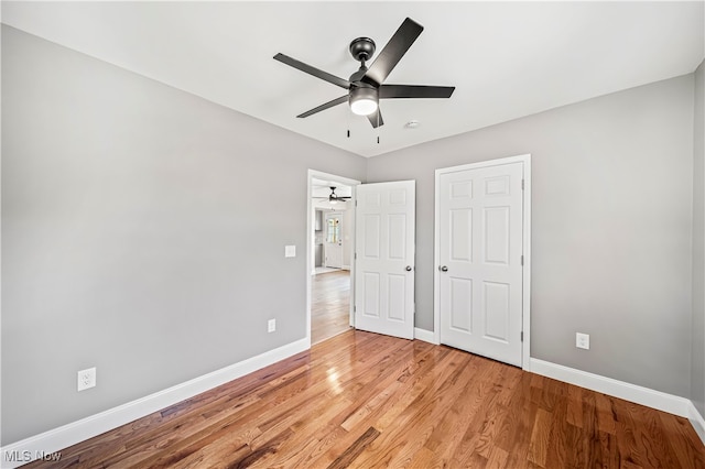 unfurnished bedroom featuring ceiling fan and light hardwood / wood-style flooring