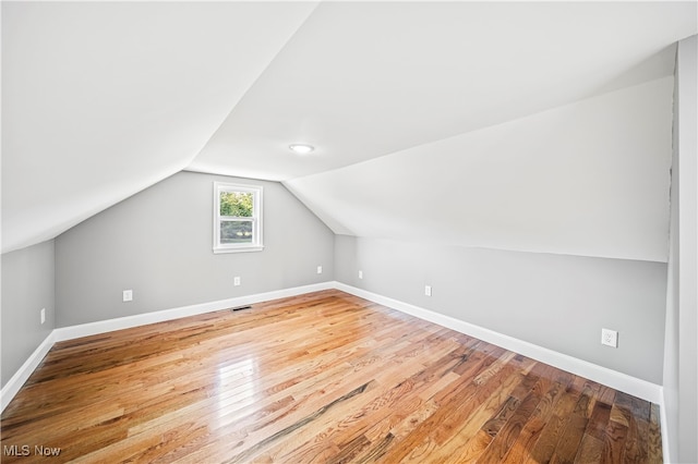 bonus room featuring hardwood / wood-style flooring and lofted ceiling