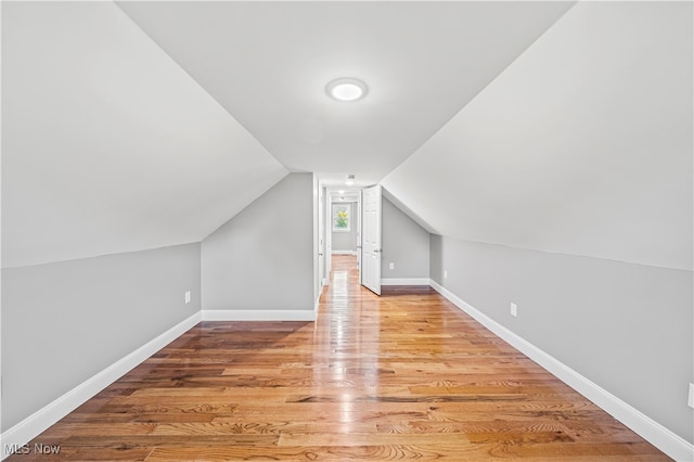 bonus room featuring lofted ceiling and hardwood / wood-style floors