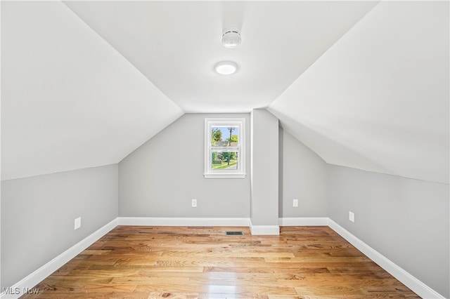 bonus room featuring hardwood / wood-style flooring and lofted ceiling