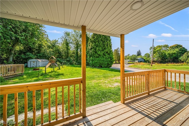 wooden terrace with a yard and a shed