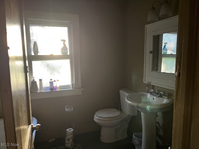 bathroom featuring toilet and a wealth of natural light