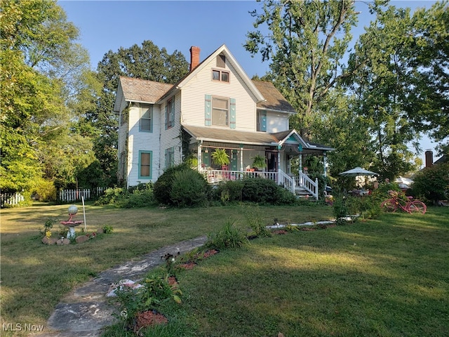 victorian house with a porch and a front yard