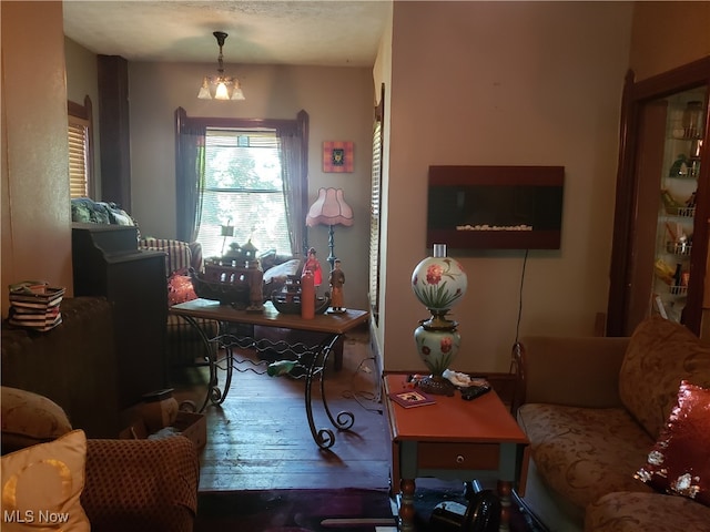 living room featuring hardwood / wood-style floors and an inviting chandelier