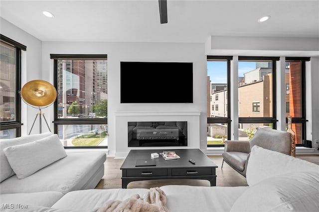 living room featuring a wealth of natural light, hardwood / wood-style flooring, and ceiling fan