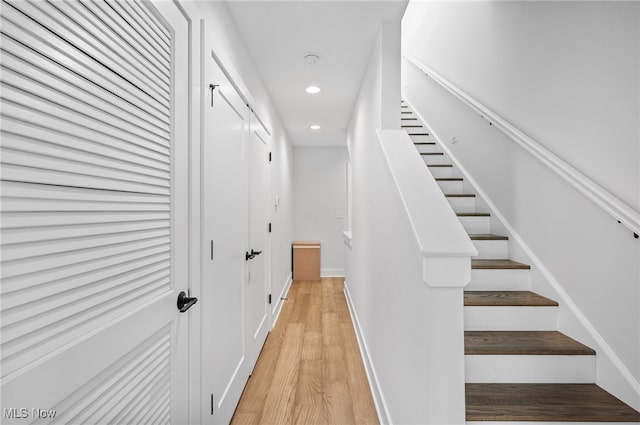 stairs featuring hardwood / wood-style flooring