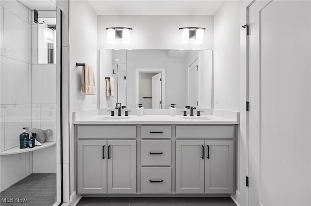 bathroom with vanity, tile patterned flooring, and an enclosed shower