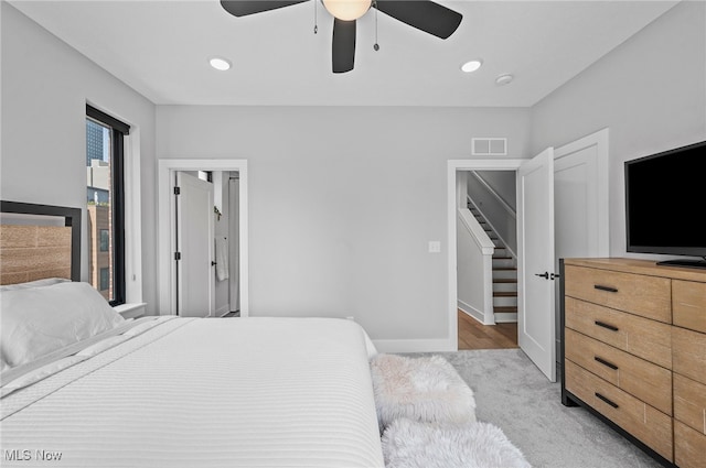 bedroom featuring ceiling fan and light carpet