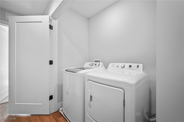 washroom with independent washer and dryer and hardwood / wood-style floors