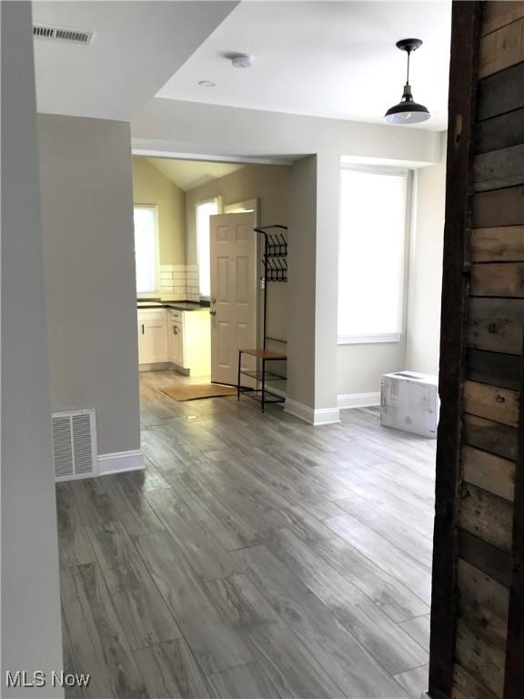 spare room with plenty of natural light and hardwood / wood-style floors