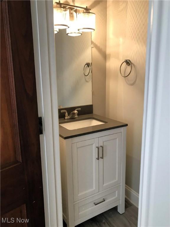 bathroom with vanity and hardwood / wood-style floors