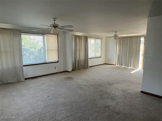 unfurnished room with ceiling fan and carpet flooring