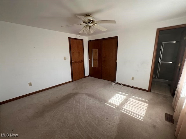 unfurnished bedroom featuring a closet, ceiling fan, and light carpet