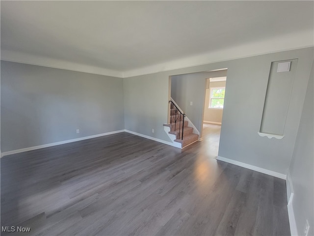 empty room with dark hardwood / wood-style flooring