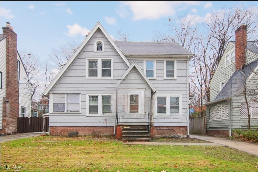 tudor home featuring a front lawn