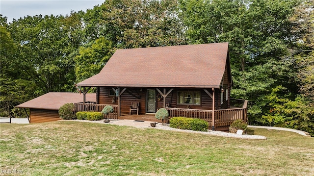 log-style house with a porch and a front yard