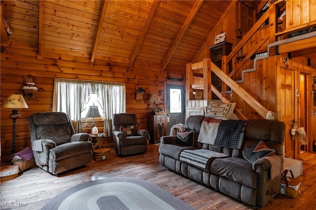 living room with wood ceiling, beamed ceiling, wooden walls, and hardwood / wood-style flooring