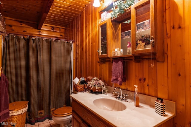 bathroom featuring toilet, wooden walls, tile patterned flooring, vanity, and wooden ceiling