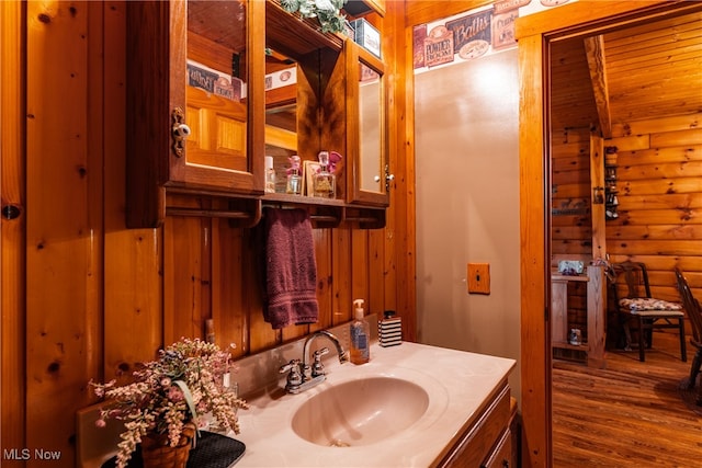 bathroom featuring wooden ceiling, vanity, hardwood / wood-style floors, and wood walls