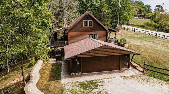 view of front facade with a front lawn and a wooden deck