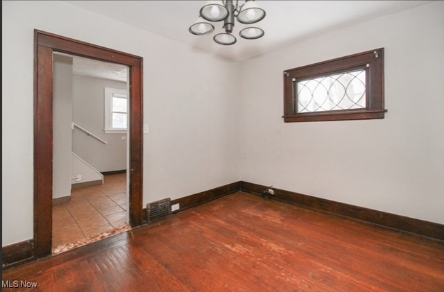 spare room with hardwood / wood-style floors