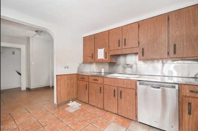 kitchen with dishwasher, tasteful backsplash, sink, and light tile patterned flooring