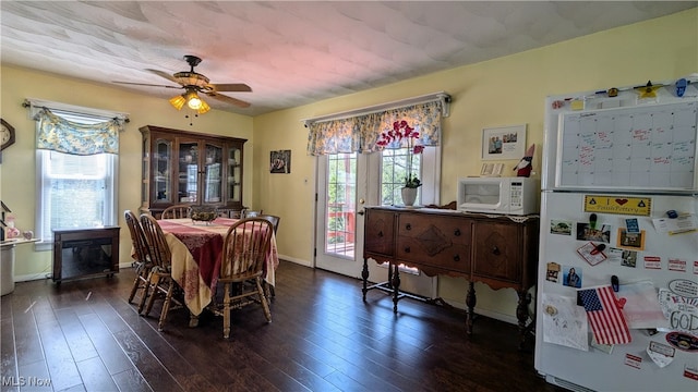 dining area featuring ceiling fan and dark hardwood / wood-style flooring