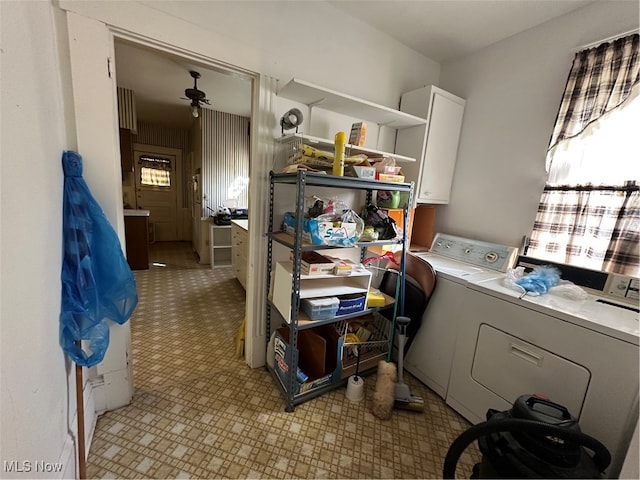 laundry room featuring ceiling fan, cabinets, and separate washer and dryer